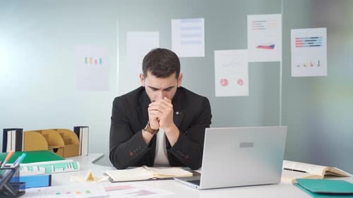 Businessman thoughtful in his office.