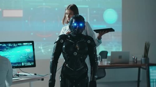 Female Robotics Engineer Control Automated Robot with Digital Tablet Giving Commands Multiethnic