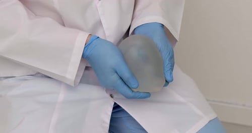 Medical Professional Holding Silicone Breast Implant
