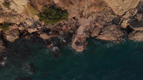 The Camera Flies to the Left Along the Rocky Seashore