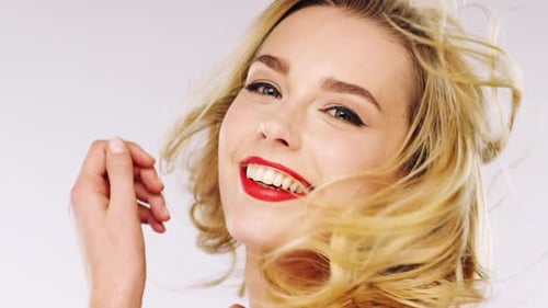 4k video footage of a glamorous young woman posing against a studio background