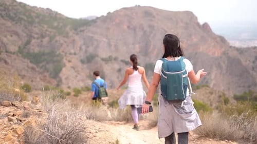 Hikers group walk along a rout in the mountain.