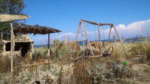 Abandoned Beach Playground in Sunny Coastal Setting
