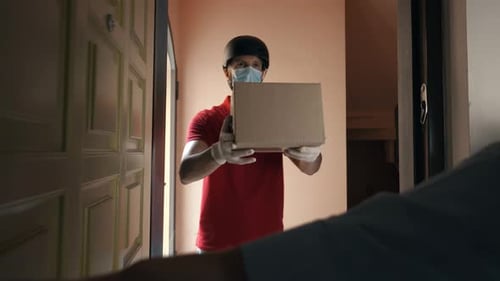 Delivery Person Handing Box at Doorway