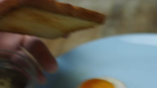Hands Spreading Green Paste onto Toast Slice