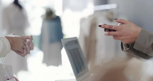 4k video footage of a customer doing a payment using her card in a boutique