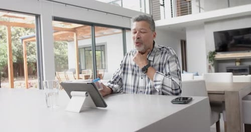 Man Telehealth Consultation at Kitchen Island