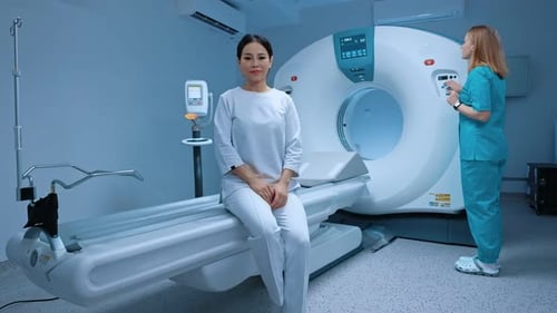 Woman Seated Before a Modern CT Scanner
