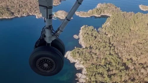Outstretched wheel of a flying airplane, close up view.