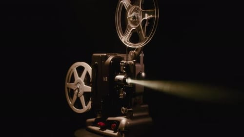 Vintage Film Projector Casting Bright Light in Darkness