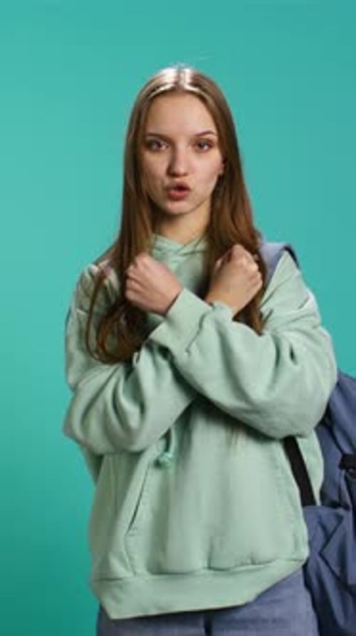 Vertical Video Assertive Woman Shows Letter X with Arms Crossed Staying in Warrior Stance