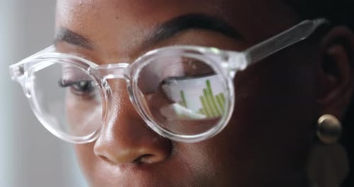 Woman Wearing Glasses Reflecting Charts