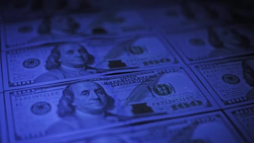 Cool Blue Lighting on US Hundred Dollar Bills