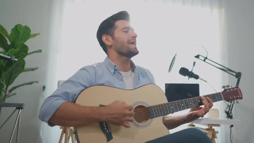 Young Adult Playing Guitar and Singing