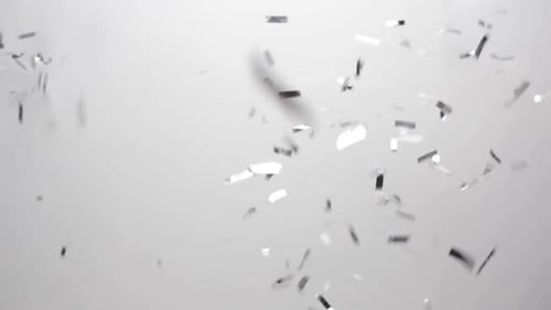 Party, Decoration and Holidays Concept - Silver Confetti Falling Over White Background Background