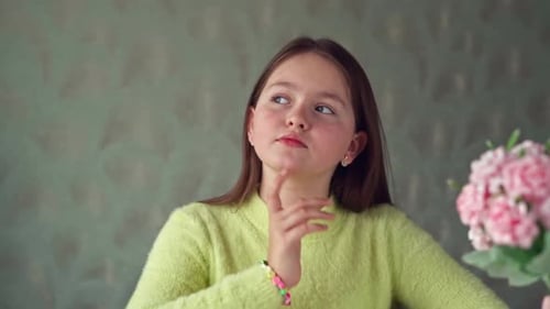 Portrait of a Thoughtful Little Girl Looking out the window. Thoughtful look