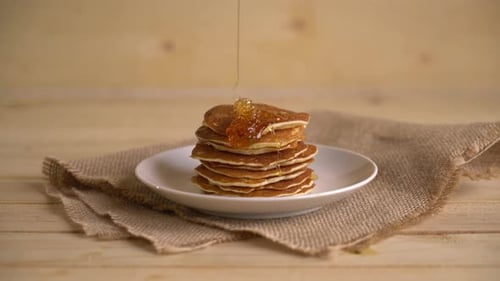 Honey Drizzled Over Stack of Golden Pancakes