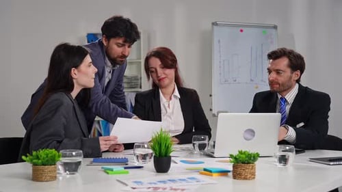Business Meeting with Four People in Office Setting