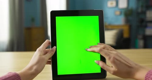 Hands Using Tablet with Green Screen at Home
