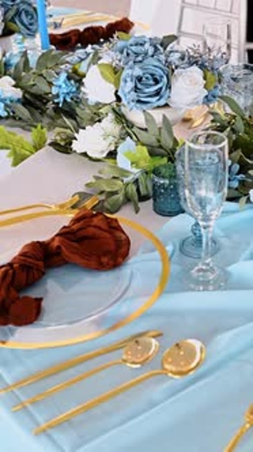 Wedding Table Decoration With Blue Flowers and Gold Details