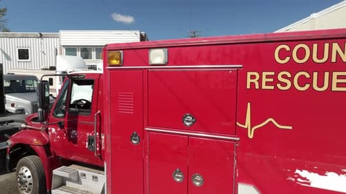 A View of an Emergency Medical Services (EMS) Vehicle From the Left - Pullback Shot