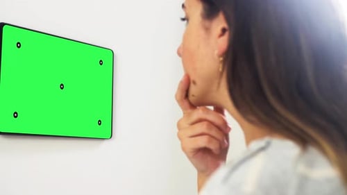 Woman Thinking in Front of Green Screen Tablet
