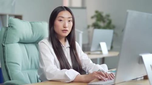 Woman working at computer in office setting