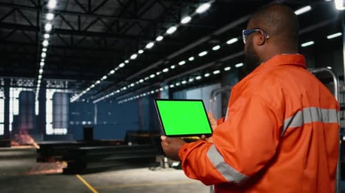 Green Screen Tablet with Worker Managing Operation Tasks Across Factory Floor
