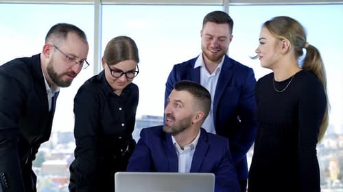Group of happy young business people in a meeting at office. Teamwork, brainstorming concept.