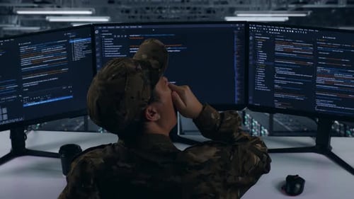 Back View Of Tired Asian Military Yawning Before Sleeping While Write Code In Data Center