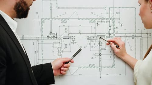 Architects Reviewing Blueprint Together in the Office