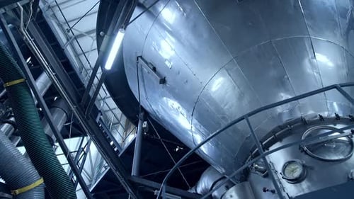 Tank at milk factory. Dairy factory industrial equipment with metal tubes