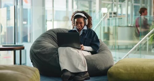 Laptop, headphones and music with woman in college for study playlist, streaming or elearning