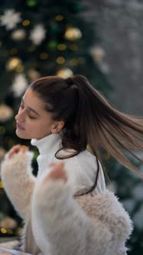 Woman Smiling in Front of Christmas Tree