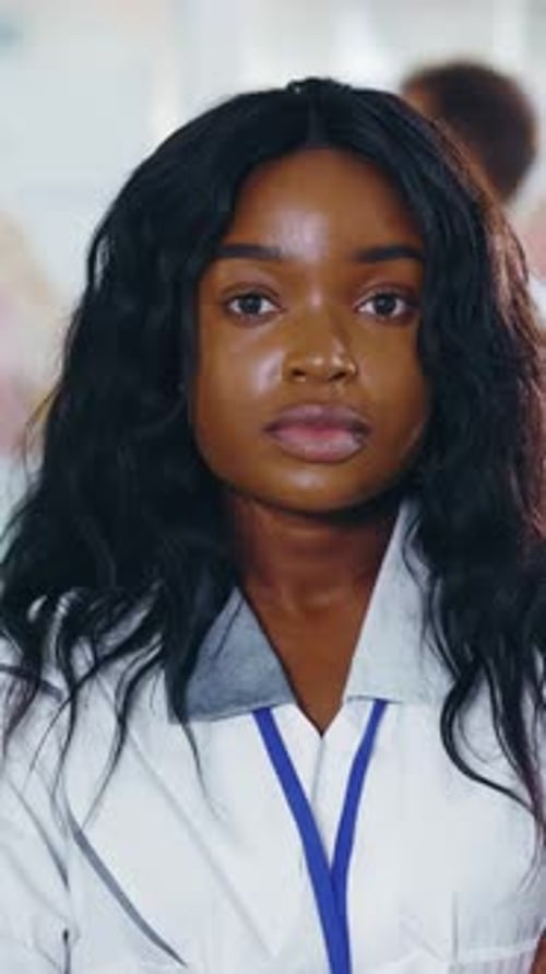 Young Woman in White Coat in Healthcare Setting