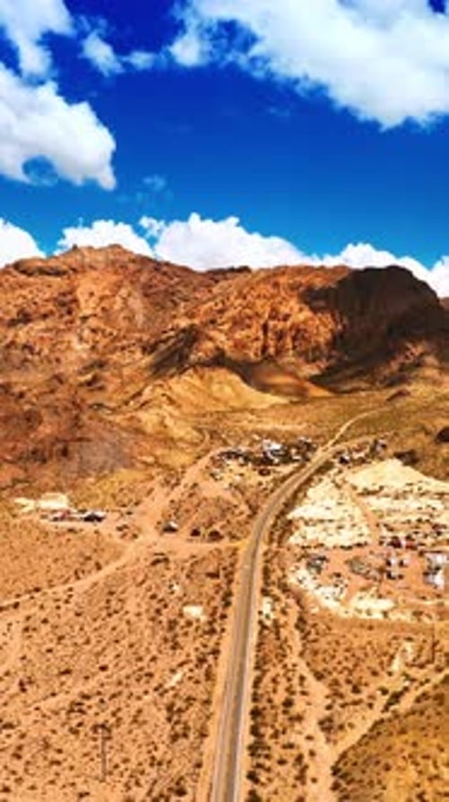 Vallée déserte de Mojave avec autoroute et quelques maisons entre les montagnes