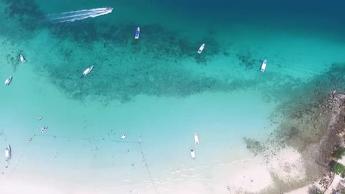 A Stunning Aerial View Showcasing Boats Gracefully Floating on the Clear Tropical Waters