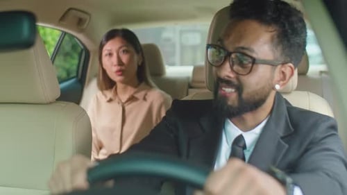 Taxi Driver Speaking with Businesswoman in Car