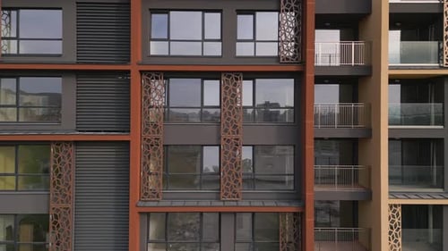 Aerial View of a Drone Flying Around and Along the Facade of a Modern Residential Building