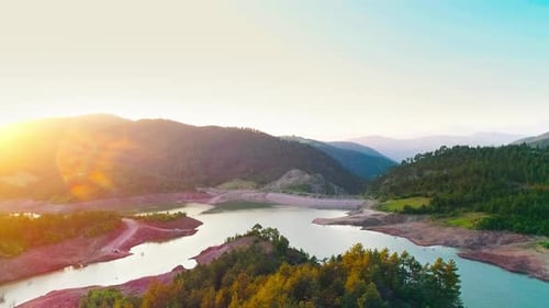 Aerial View of Forest and Lake at Sunset