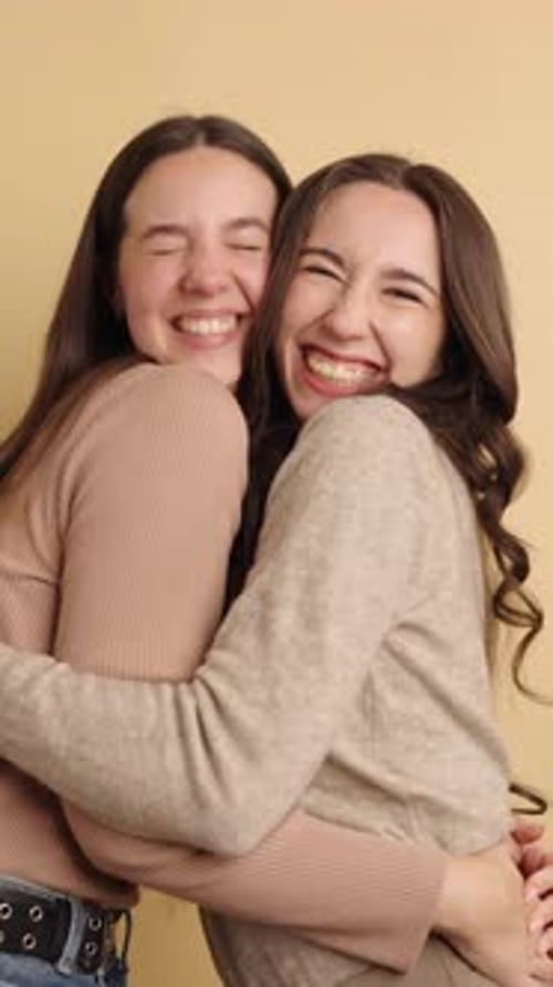 Joyful Friends Embracing and Laughing Together Indoors