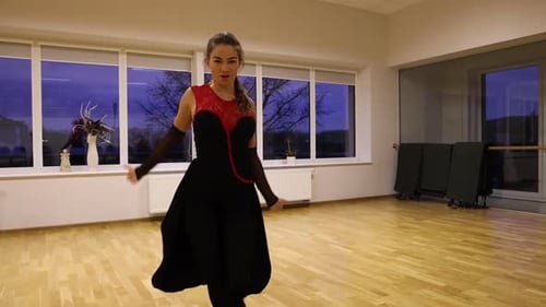 Woman Dancing Elegantly in Studio with Wood Floor