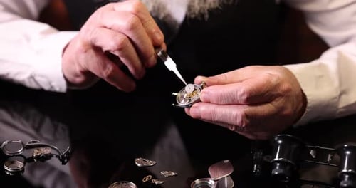 Watchmaker Repairing Intricate Mechanical Watch at Workbench