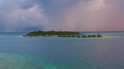 Overwater Villas at the Time Amazing Sunset in Tropical Sea with Coral Reef