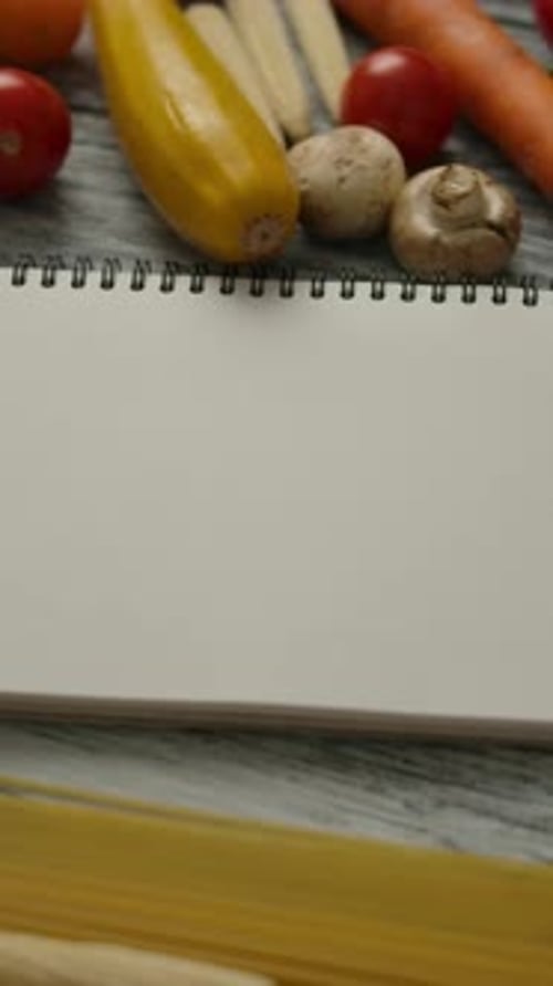 Vertical of Empty Notepad Amidst Pasta Ingredients