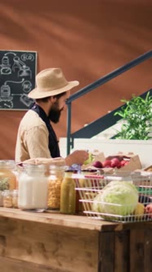 Bearded Man at Food Counter Selling Produce