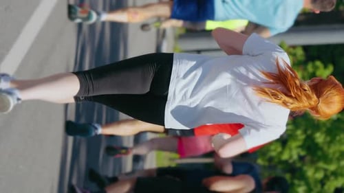 Vertical Screen Redhaired Woman Running City Marathon in Slow Motion