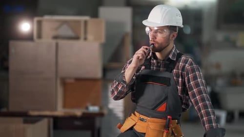 Man Vaping in Workshop with Safety Gear