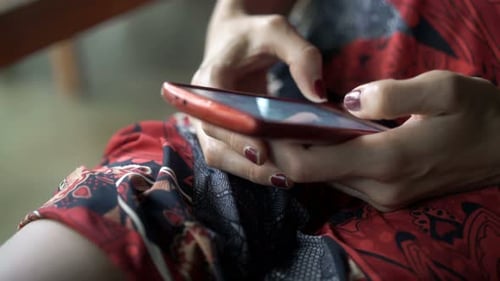 Woman Using Red Smartphone Technology Close Up