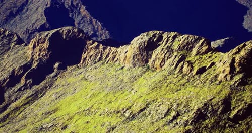 Majestic Mountain Landscape with Vibrant Green Slopes and Rocky Peaks